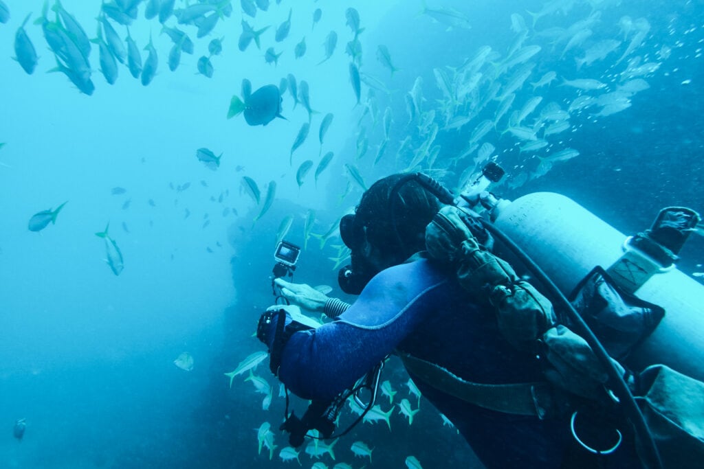 Scuba diver recording gopro video underwater